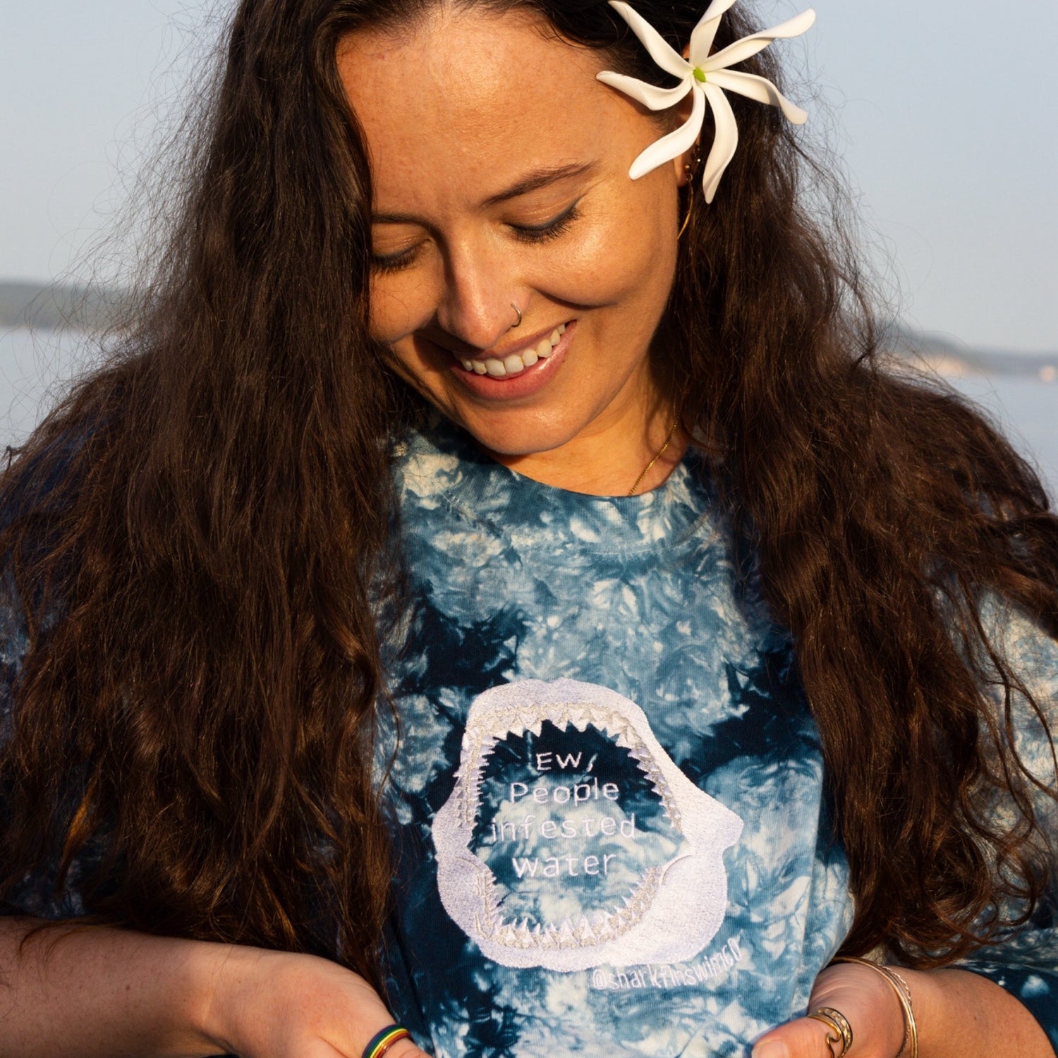 Blue and white tie dye cotton t shirt with white embroidered ew people infested water inside of a shark jaw