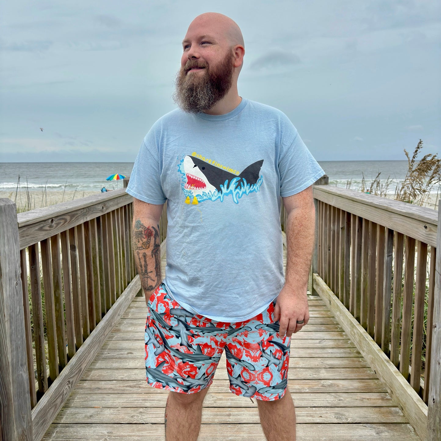 Fin & Fierce Hammerhead sustainable swim trunks blue and red background