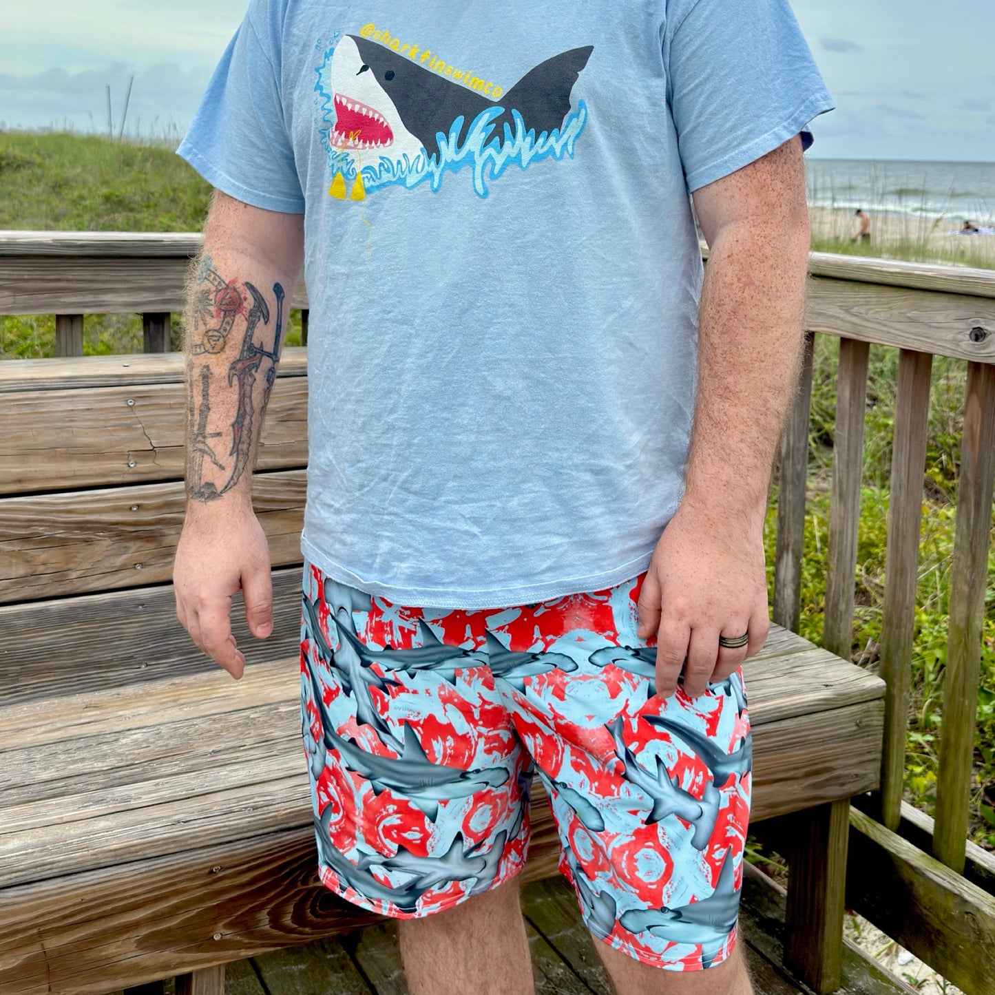 Fin & Fierce Hammerhead sustainable swim trunks blue and red background
