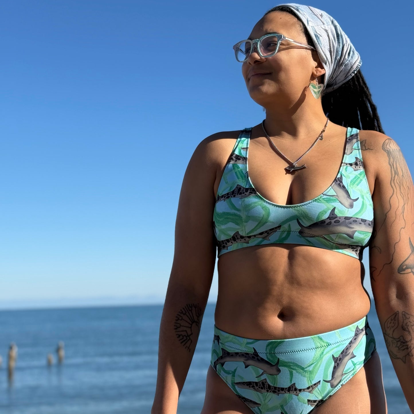 Leopard sharks on our blue and teal high waisted bikini made with recycled fabric