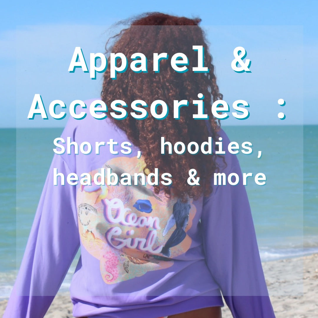 Woman wearing the purple ocean girl hoodie facing the ocean on the beach. The text over the image says “Apparel: shorts, hoodies, headbands and more” to indicate the items in this collection of products 