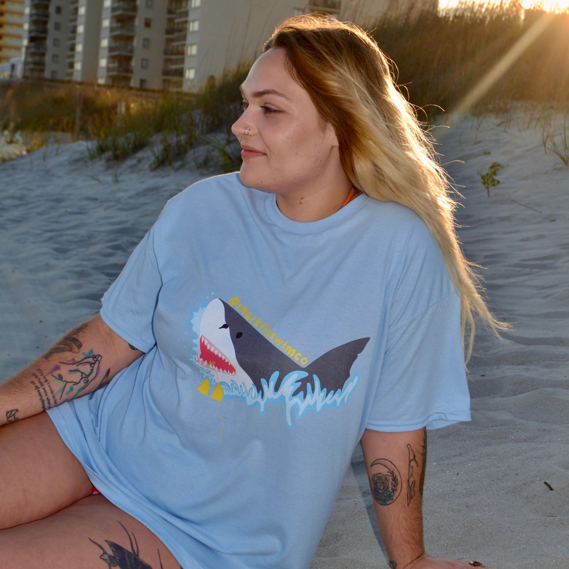 Eco-friendly t shirt with a great white shark and bikini coming out of the ocean 