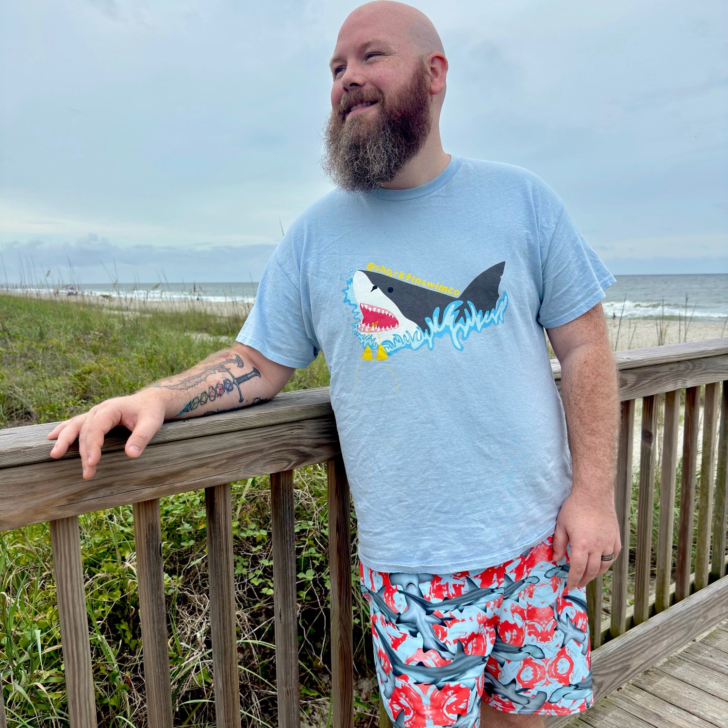Fin & Fierce Hammerhead sustainable swim trunks blue and red background