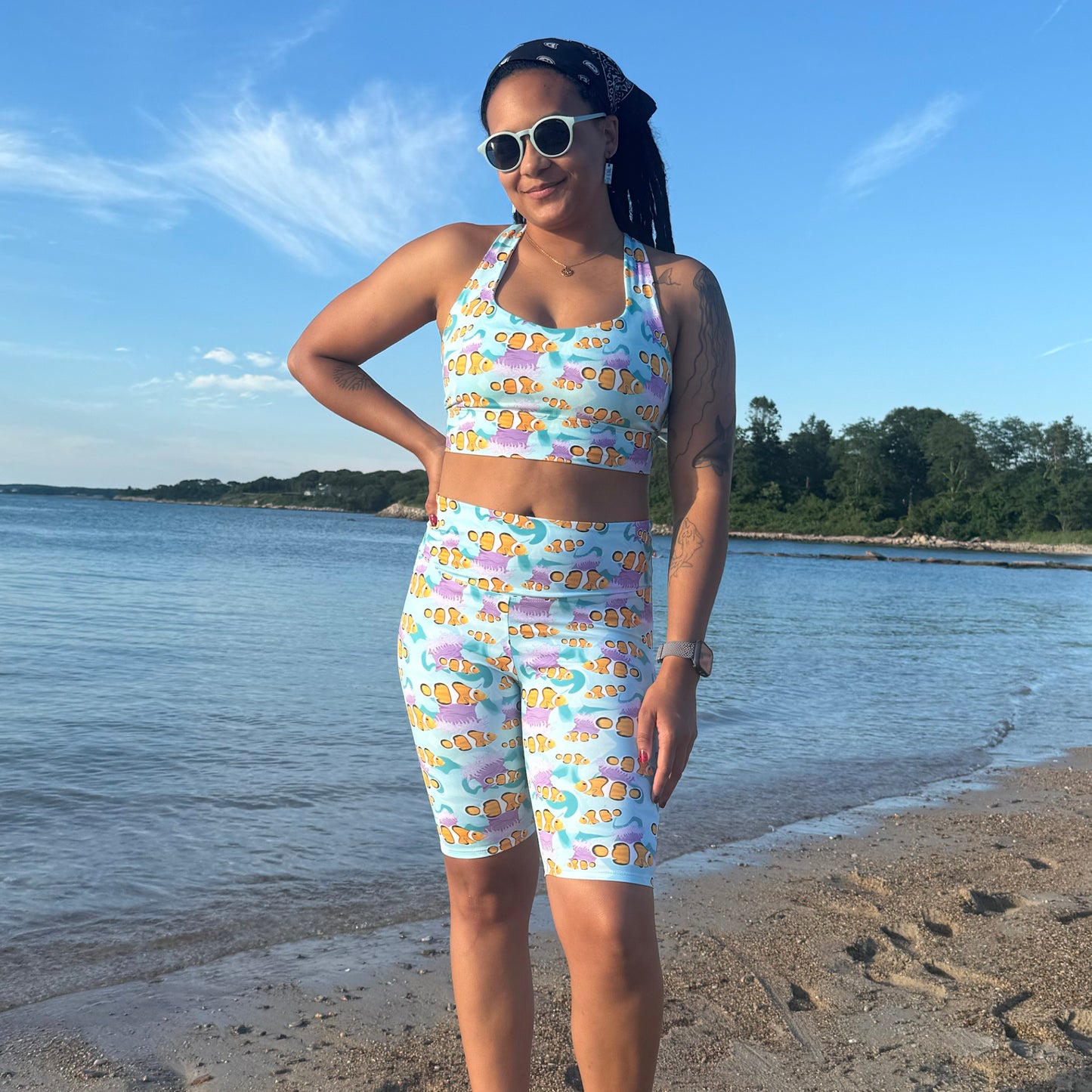 woman standing on the beach wearing blue clownfish activewear set 