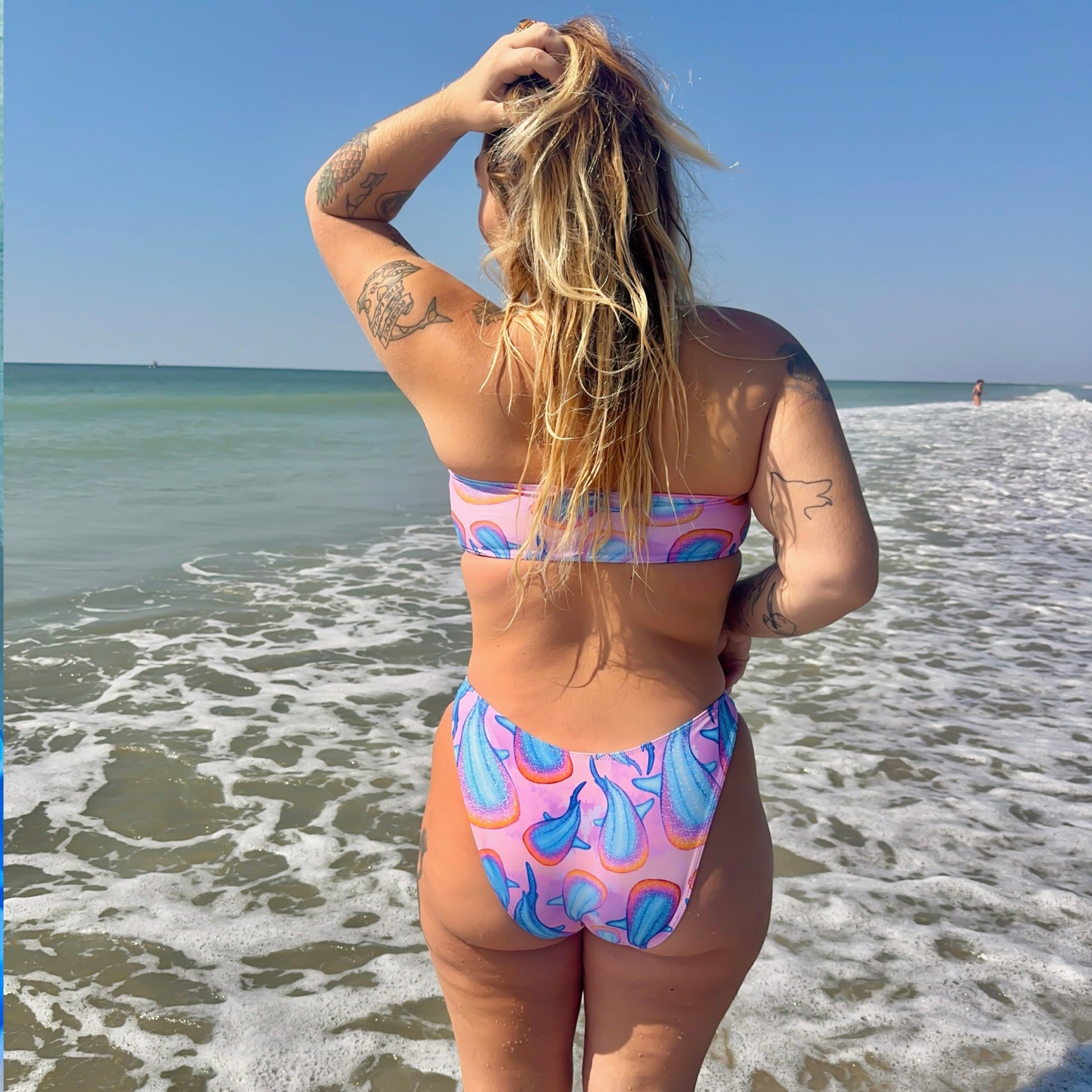 rainbow whale sharks with a pink and purple tie dye background on our high cut recycled bikini bottom