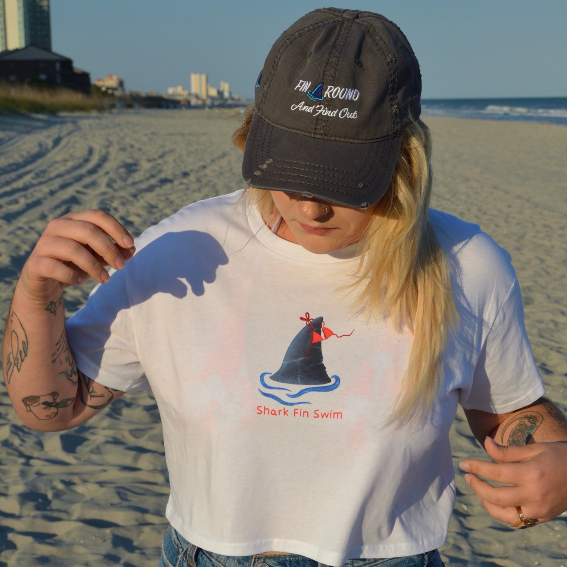 Eco-friendly distressed baseball cap with a shark fin as the A in “around” fin around and find out 