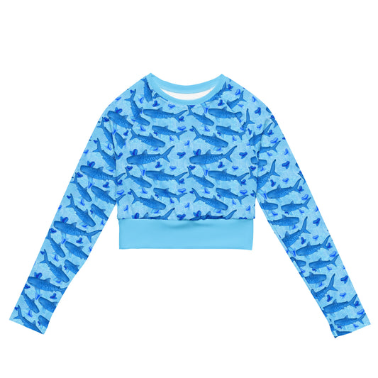Baby blue waves and Sky Blue Tiger sharks swim around royal blue tiger shark teeth on our Tiger Beach Blues Recycled cropped long sleeve rashguard 