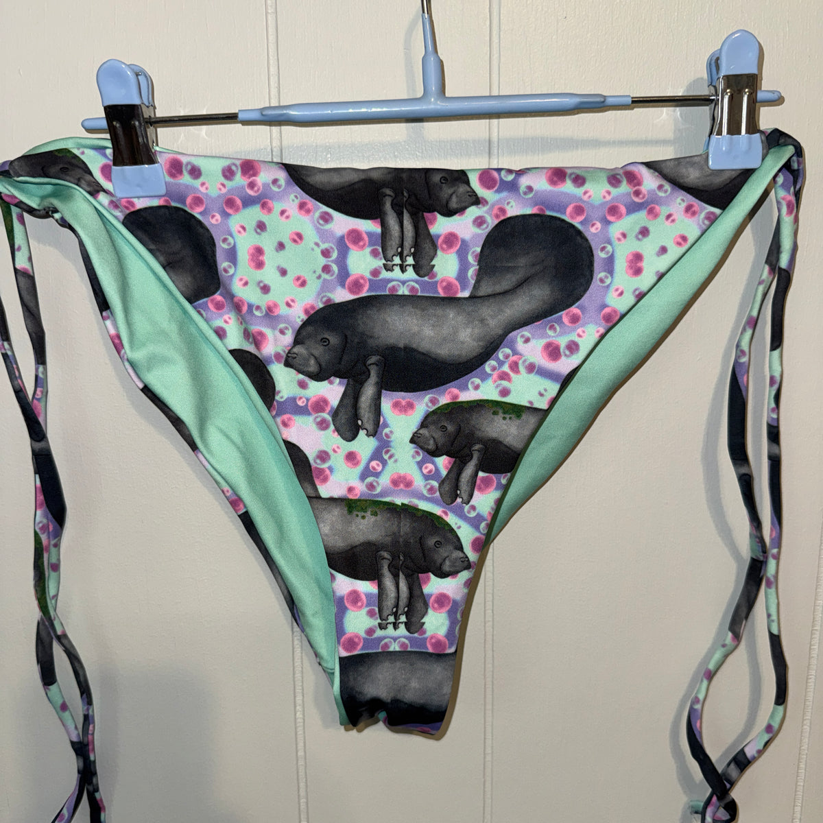Manatees with purple, mint and pink background string bikini bottoms 