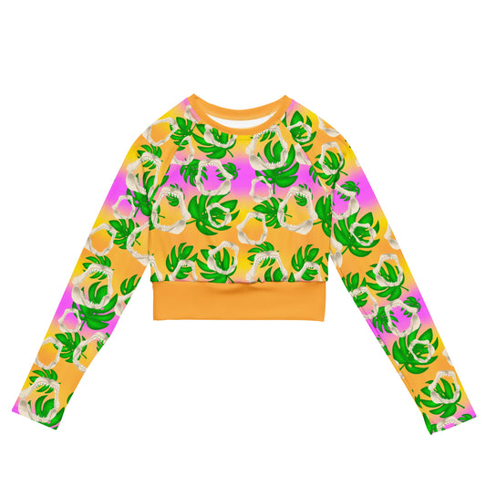 A warm golden yellow and pinky lilac sunset ombré background with megalodon jaws and monstera leaves on our Meg Monstera Recycled Cropped long sleeve rashguard 