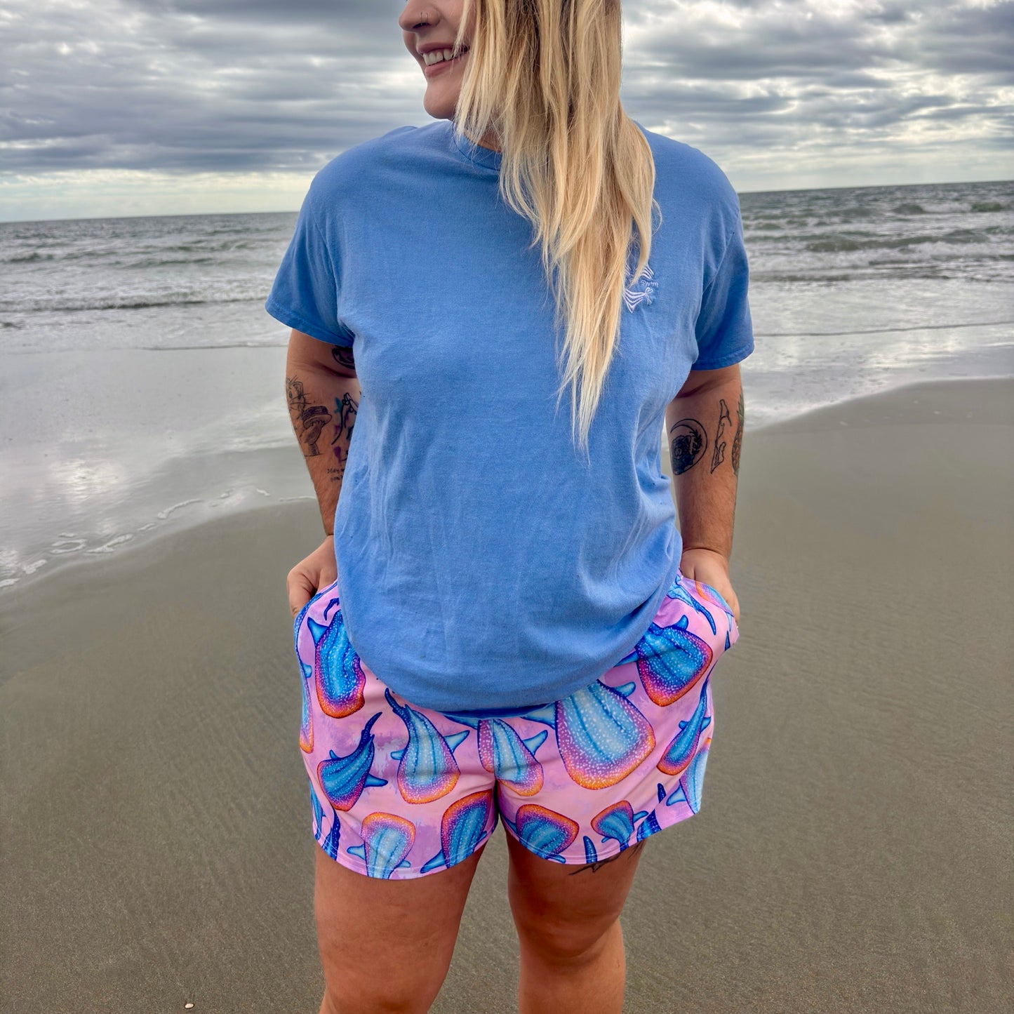 woman wearing rainbow whale shark unisex shorts 