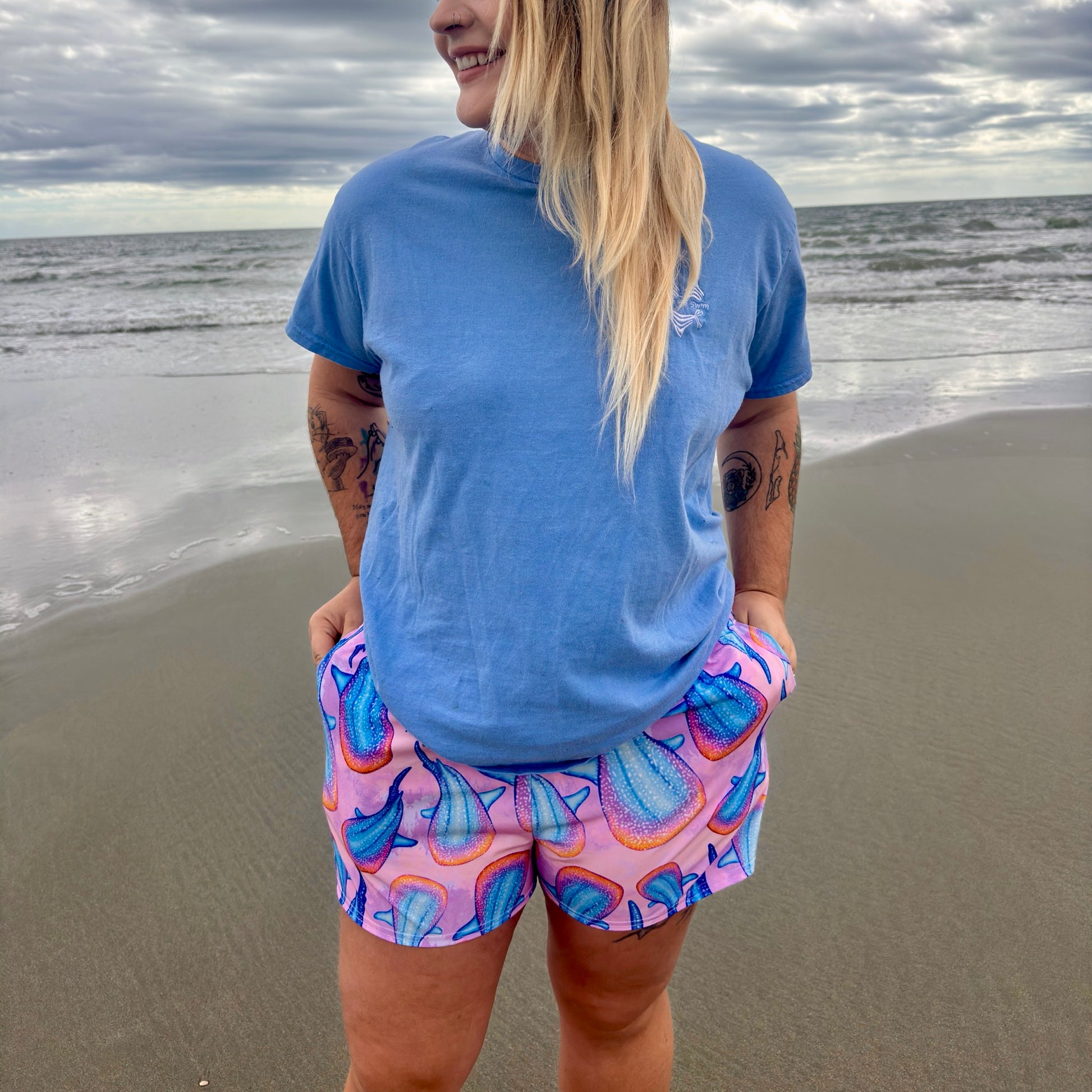 woman wearing rainbow whale shark unisex shorts 