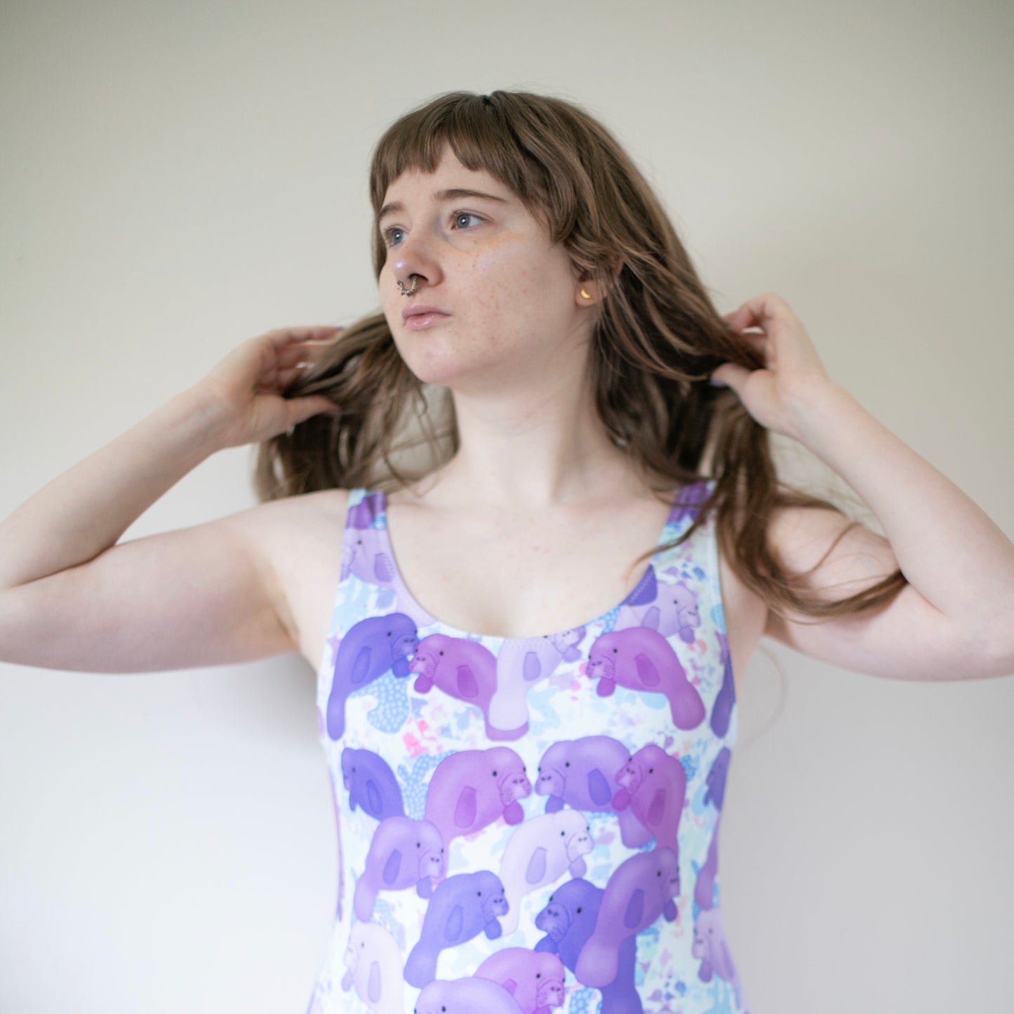 woman wearing a one piece purple manatee swimsuit 