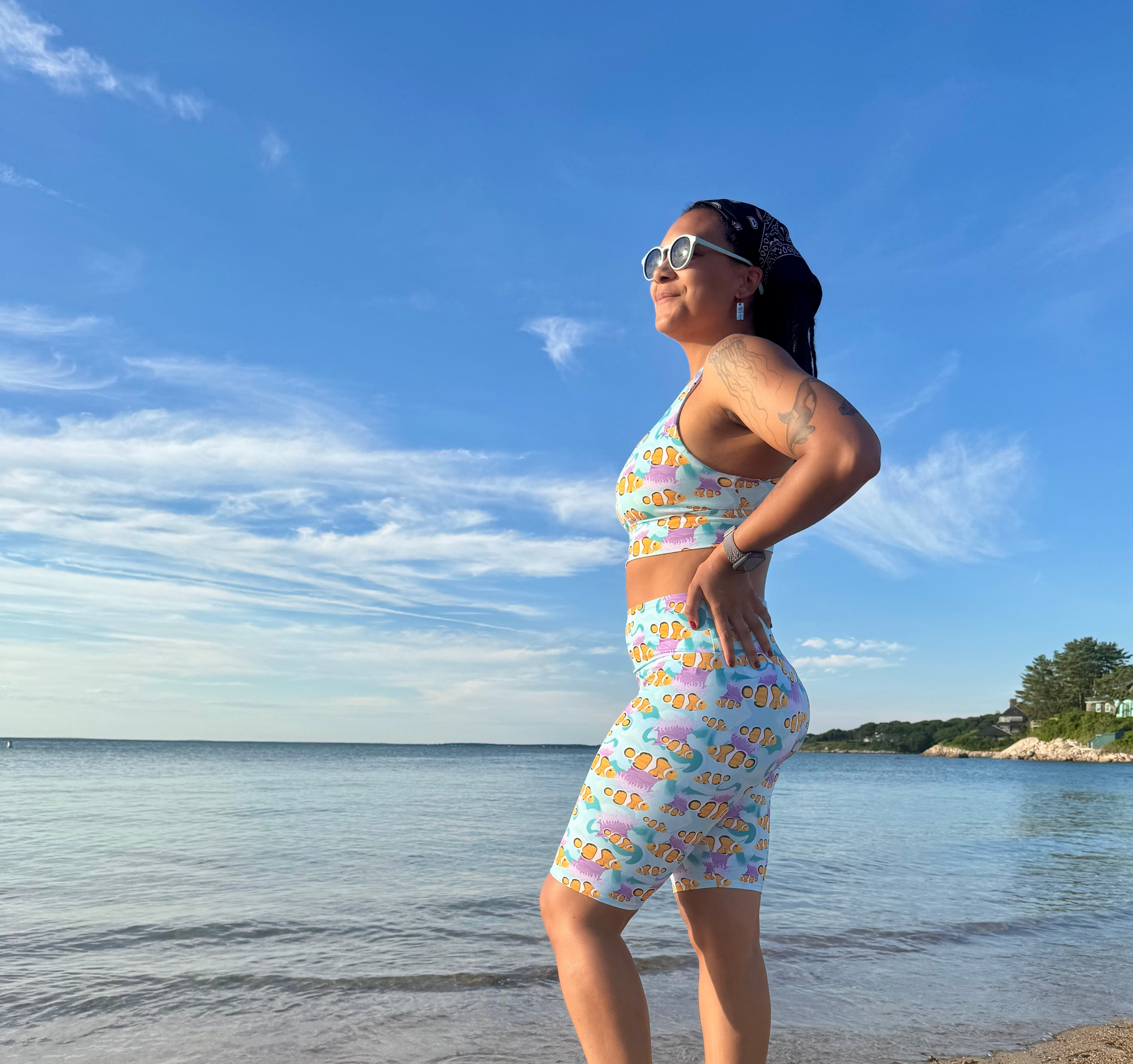 Woman on a beach wearing g clownfish activewear 