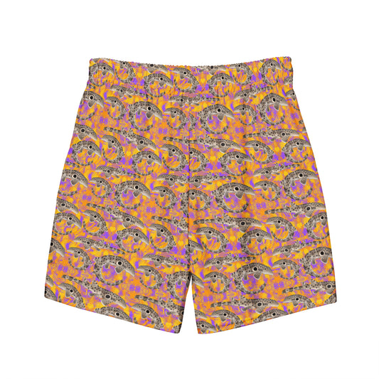 Epaulette Shark eco swim trunks with orange and purple background 