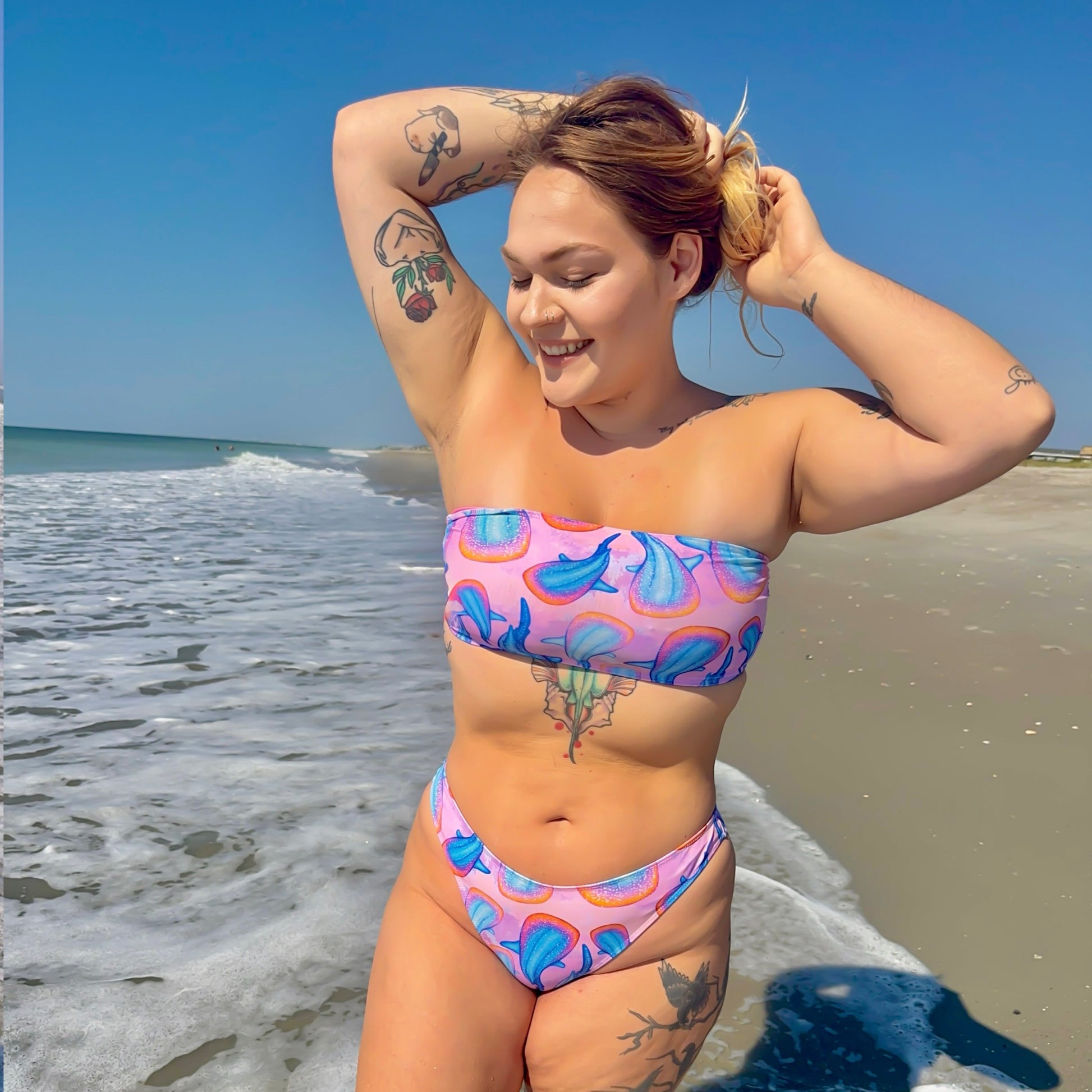 rainbow whale sharks with a pink and purple tie dye background on our recycled bikini tube top 