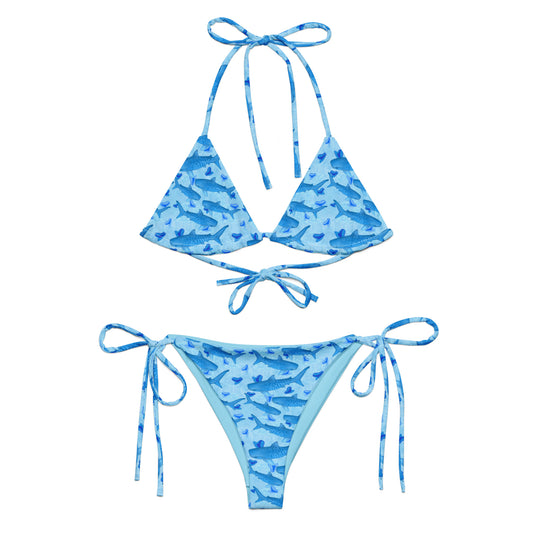 Baby blue waves and Sky Blue Tiger sharks swim around royal blue tiger shark teeth on our Tiger Beach Blues Recycled string bikini 