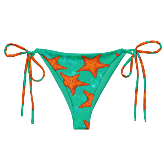 Green bikini bottom with orange star patterns on a white background