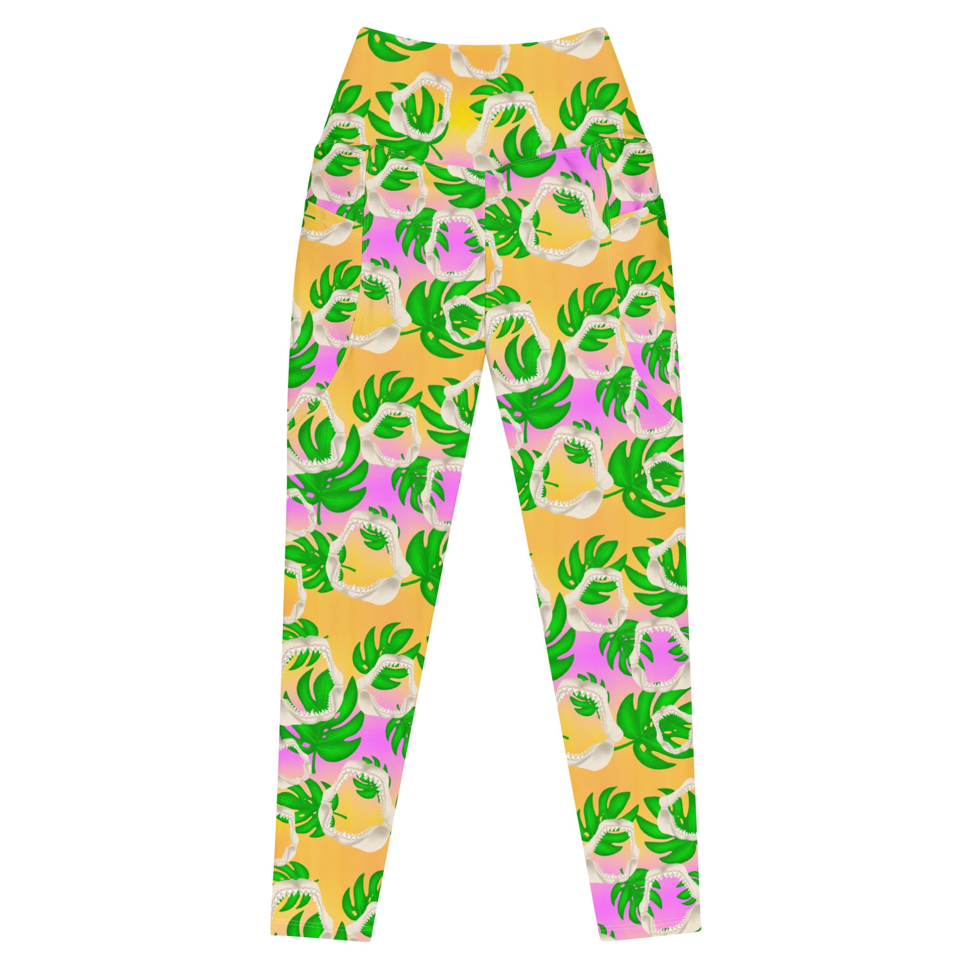 A warm golden yellow and pinky lilac sunset ombré background with megalodon jaws and monstera leaves on our Meg Monstera Recycled dive leggings with pockets 