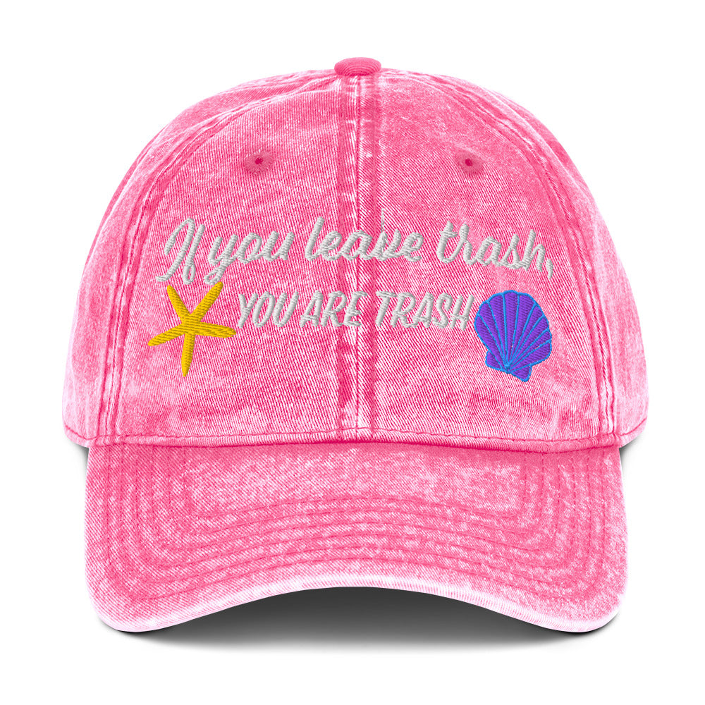 Pink baseball cap with embroidered ocean animals and text “if you leave trash, you are trash”