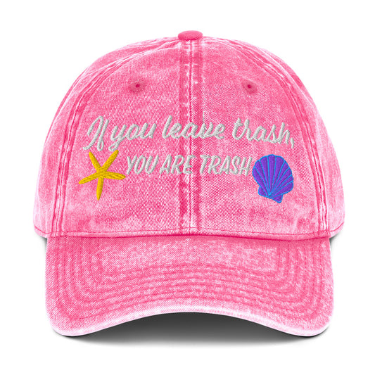 Pink baseball cap with embroidered ocean animals and text “if you leave trash, you are trash”