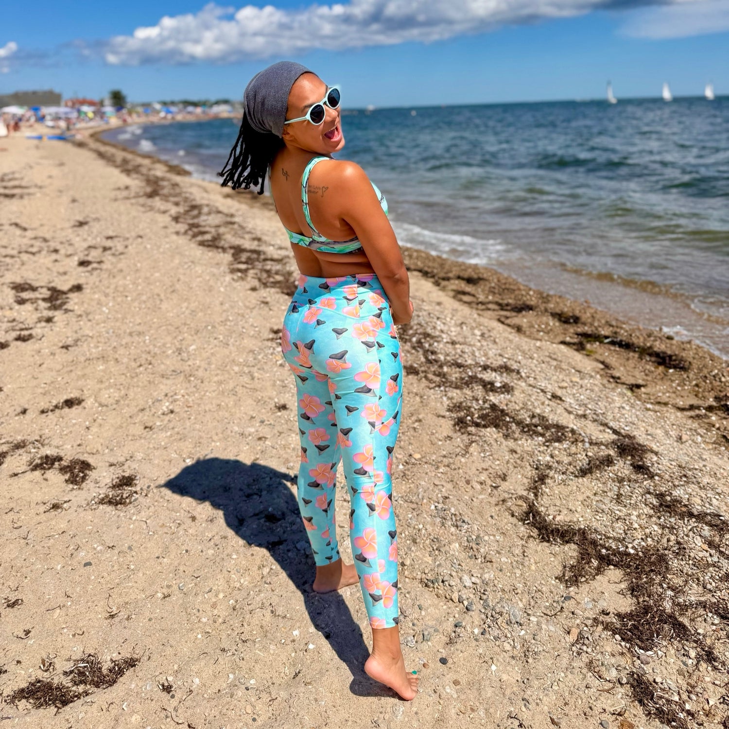 dive leggings in the shark tooth paradise print with pink plumeria flowers and shark teeth 